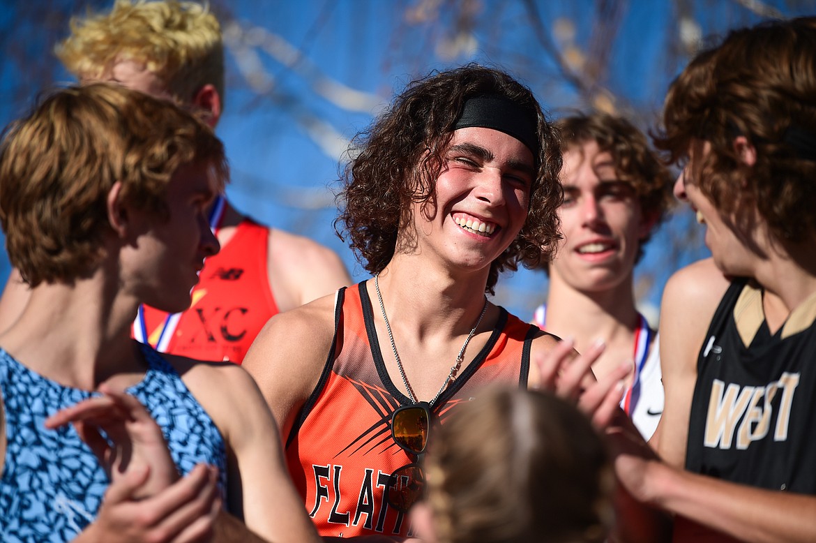 Flathead's Robbie Nuila receives his medal for a 7th place finish in the Class AA boys race at the state cross country meet at Rebecca Farm on Saturday, Oct. 21. (Casey Kreider/Daily Inter Lake)