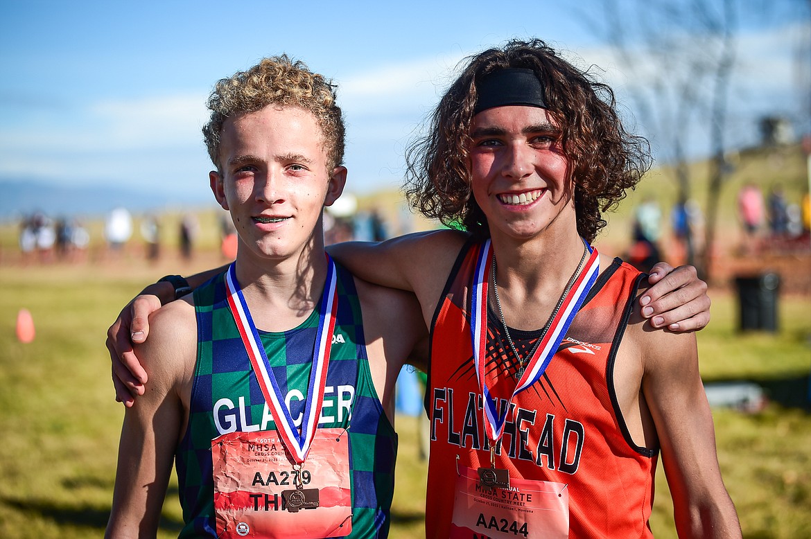 Glacier's Owen Thiel and Flathead's Robbie Nuila with their respective medals in the Class AA boys race at the state cross country meet at Rebecca Farm on Saturday, Oct. 21. (Casey Kreider/Daily Inter Lake)