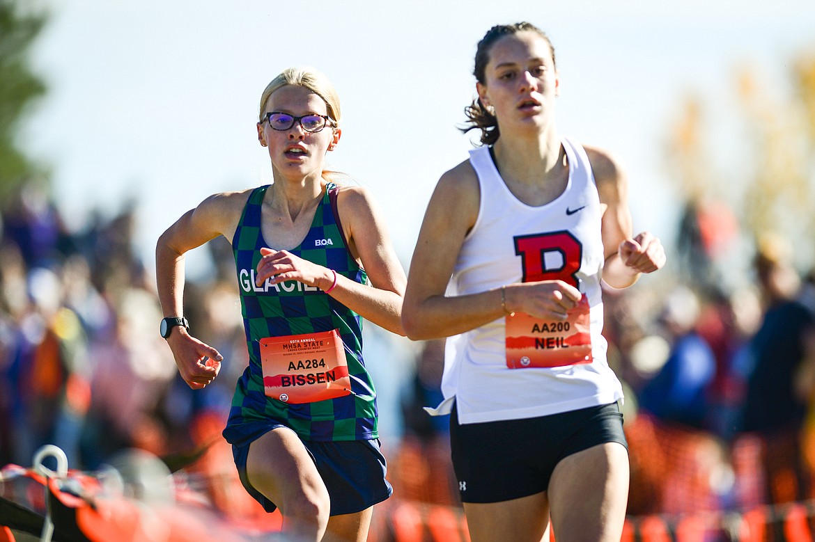 Glacier's Lauren Bissen passes Bozeman's Kylee Neil near the finish line for second place in the Class AA girls race at the state cross country meet at Rebecca Farm on Saturday, Oct. 21. (Casey Kreider/Daily Inter Lake)