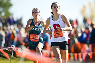 Glacier's Lauren Bissen passes Bozeman's Kylee Neil near the finish line for second place in the Class AA girls race at the state cross country meet at Rebecca Farm on Saturday, Oct. 21. (Casey Kreider/Daily Inter Lake)