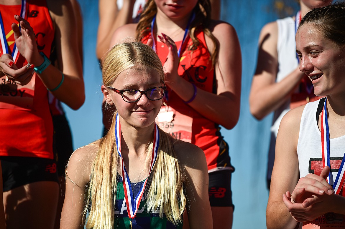 Glacier's Lauren Bissen receives her medal for a second place finish in the Class AA girls race at the state cross country meet at Rebecca Farm on Saturday, Oct. 21. (Casey Kreider/Daily Inter Lake)