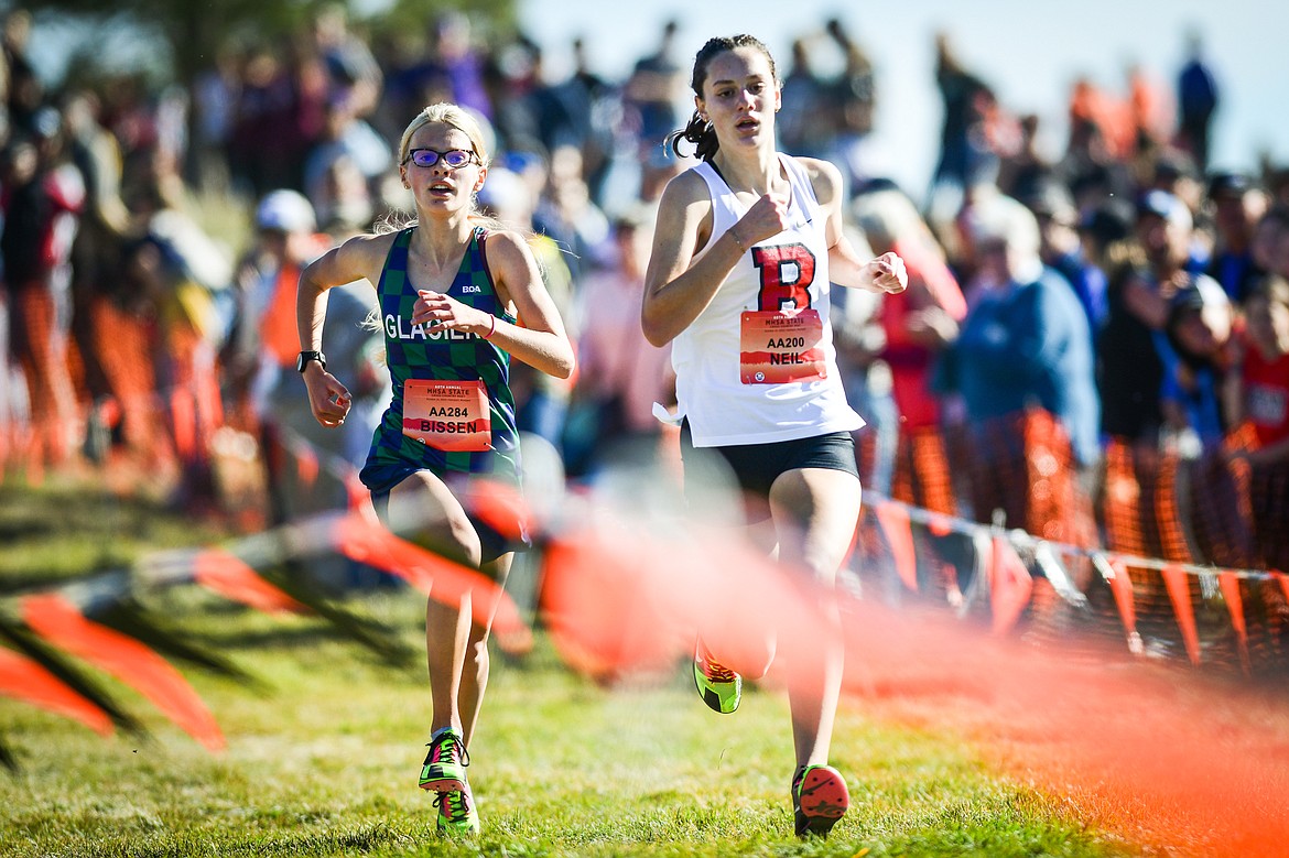 Glacier's Lauren Bissen passes Bozeman's Kylee Neil near the finish line for second place in the Class AA girls race at the state cross country meet at Rebecca Farm on Saturday, Oct. 21. (Casey Kreider/Daily Inter Lake)