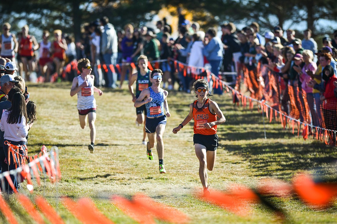 Flathead's Robbie Nuila and Glacier's Owen Thiel near the finish line in the Class AA boys race at the state cross country meet at Rebecca Farm on Saturday, Oct. 21. (Casey Kreider/Daily Inter Lake)