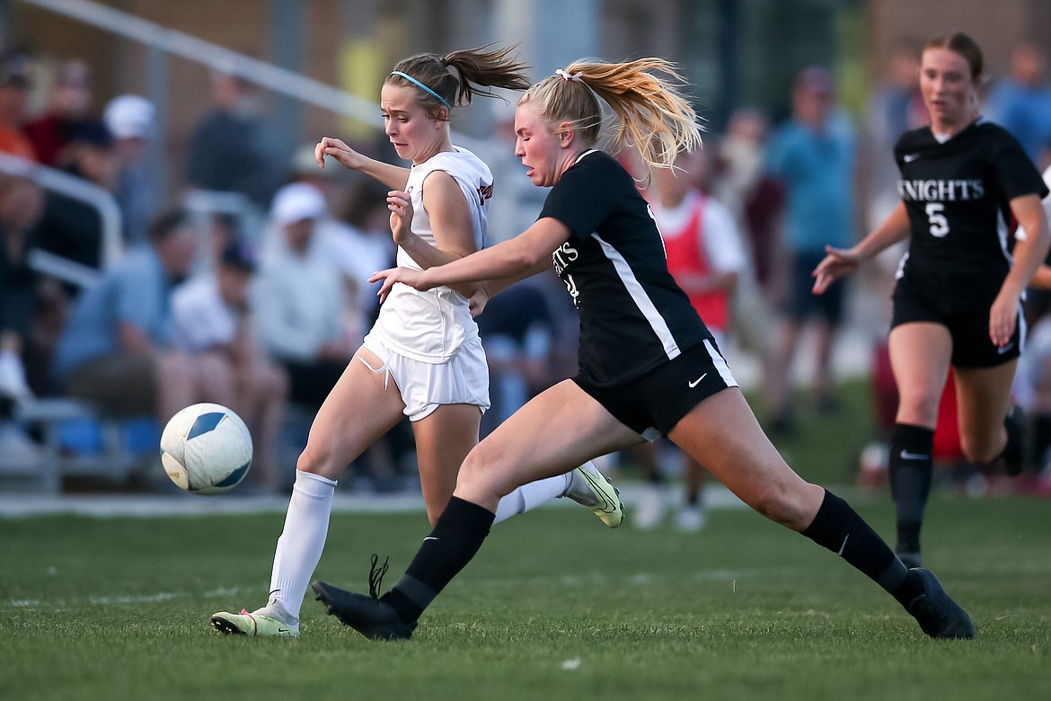 Sandpoint's Marlee McCrum passes a Bishop Kelly defender during the state championship match on Saturday. McCrum scored a goal during the 79th minute to lift the Bulldogs to a 2-1 victory.