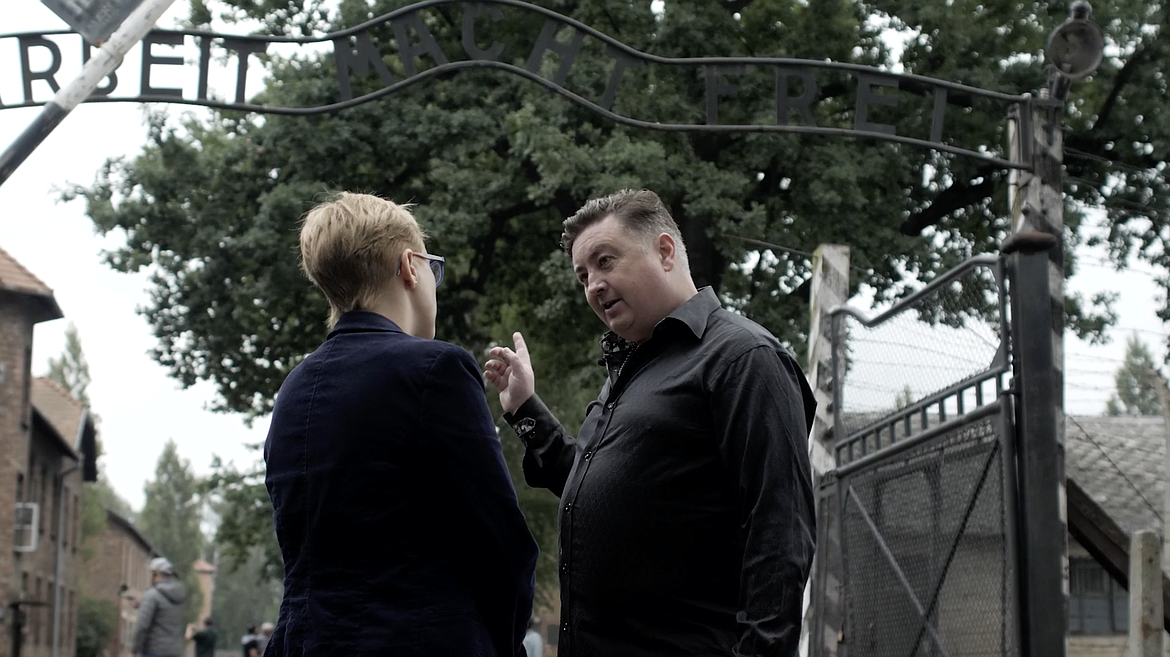 Former skinhead Tony McAleer, now an anti-hate activist and life coach, is pictured at Auschwitz in a still from the documentary, "The Cure For Hate".