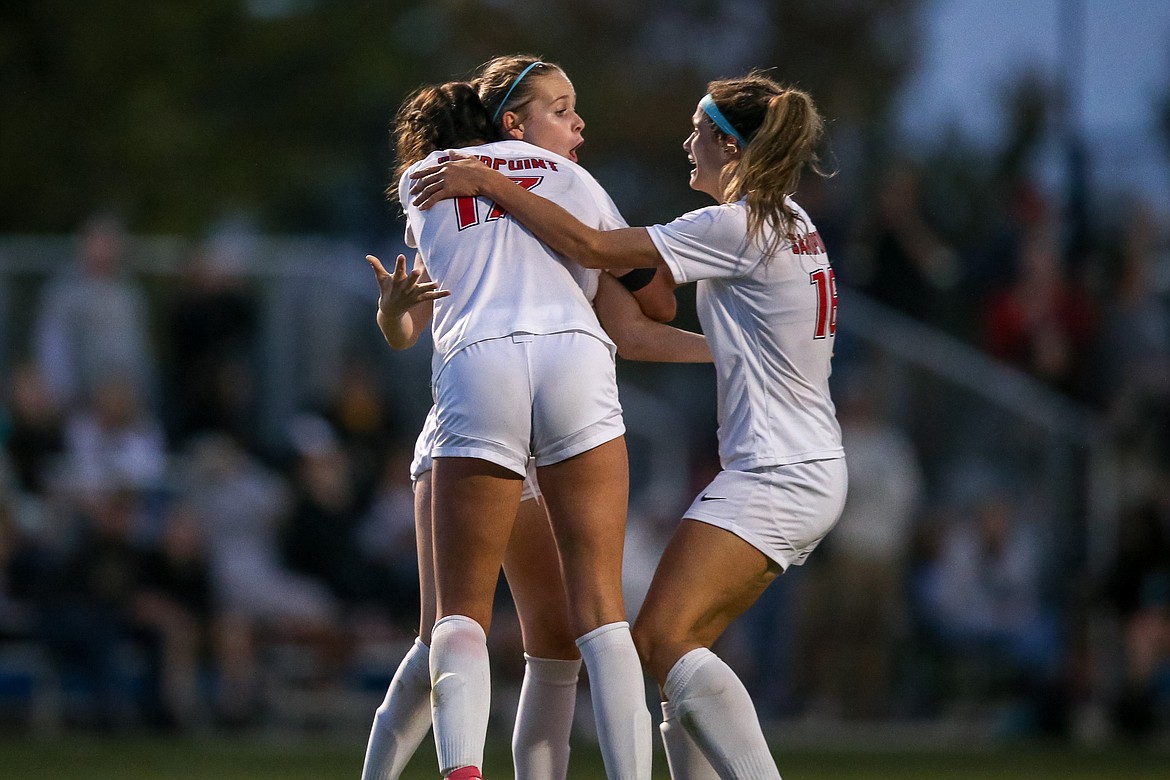 Sandpoint junior Marlee McCrum celebrates with seniors Hannah Harvey (17) and Aliya Strock (18) after scoring the go-ahead goal on Saturday.