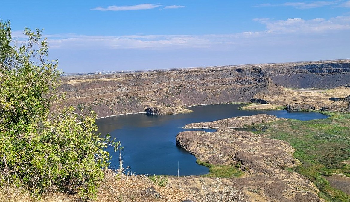 Sun shines over the view from the Dry Falls State Park Visitors Center earlier this year. While we’ll see a bit of sun this week, temperatures will be cooler and there will likely be a sprinkle or two.