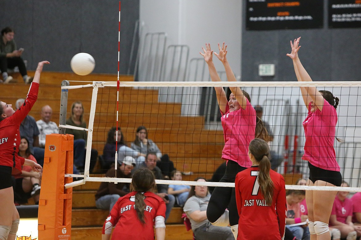 Ephrata senior Addison Mills, left in pink, and junior Addyson Hines, right in pink, leap up to attempt a block. The Tigers held the height advantage over the Red Devils on Thursday night, finding success performing blocks and kills.