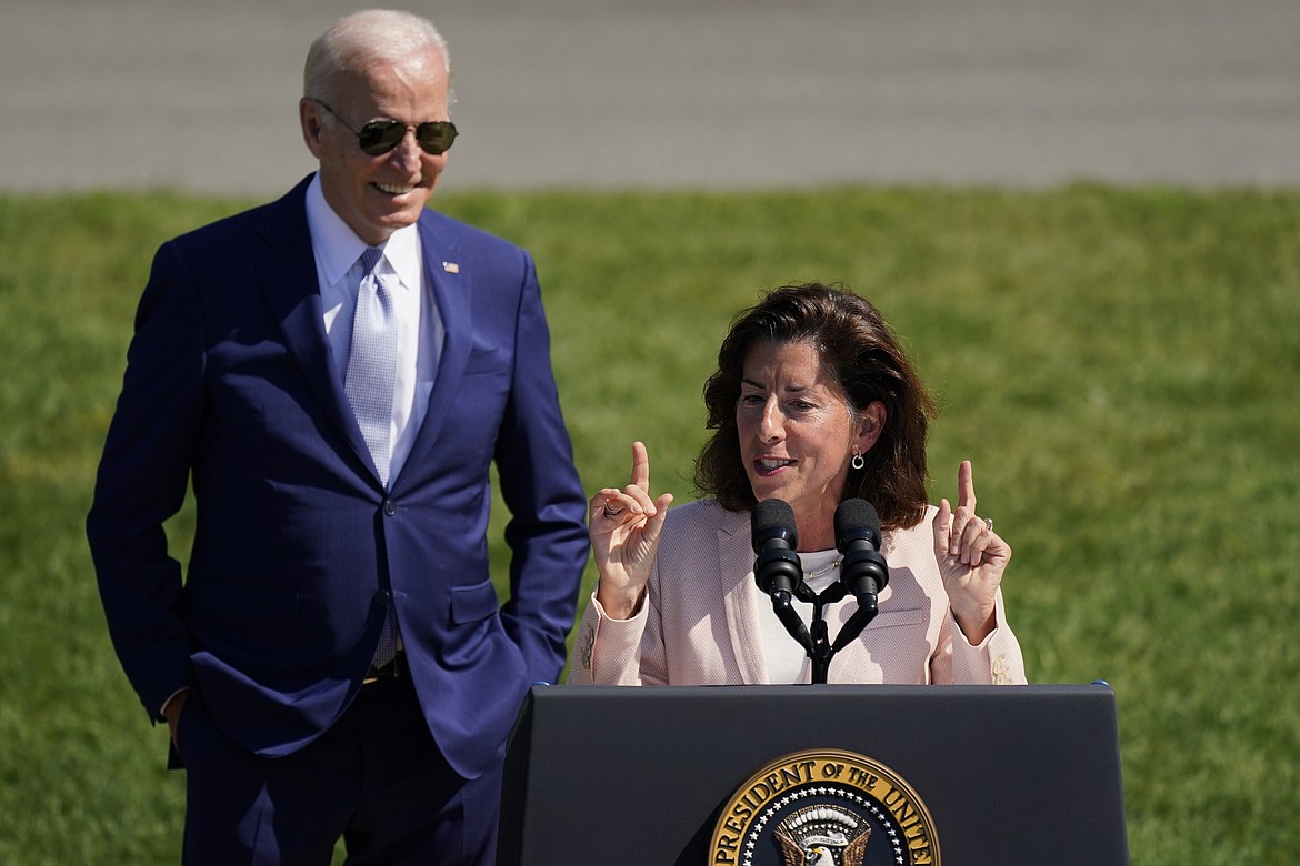 President Joe Biden looks on as Commerce Secretary Gina Raimondo speaks on the South Lawn of the White House, Aug. 9, 2022, in Washington. The Biden administration is designating 31 “tech hubs” in 32 states and Puerto Rico to help spur innovation and create jobs in the specific industries that are concentrated in these areas. “I have to say, in my entire career in public service, I have never seen as much interest in any initiative than this one," Raimondo told reporters during a Sunday, Oct. 22, 2023, conference call to preview the announcement. (AP Photo/Carolyn Kaster, File)