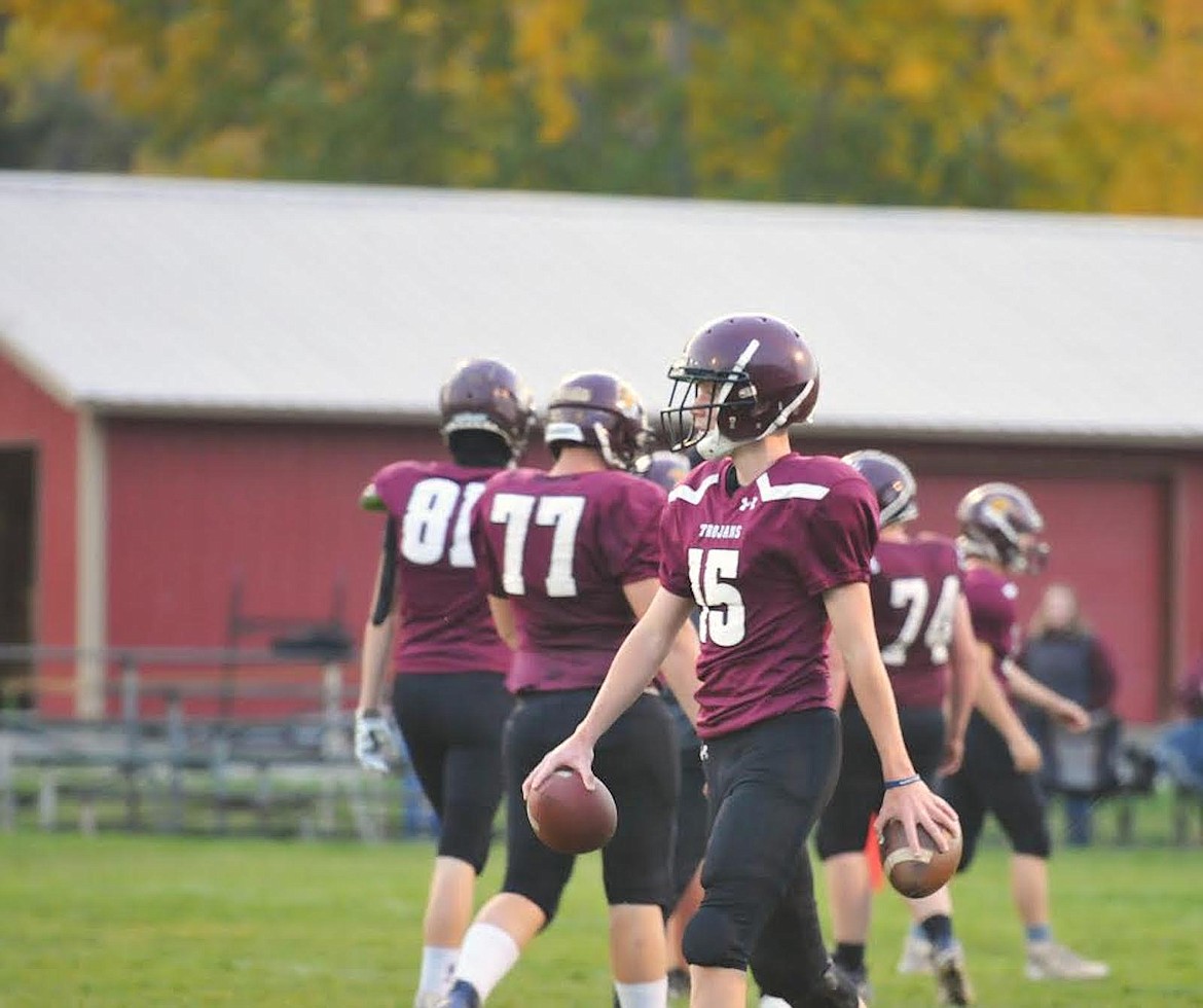 Troy quarterback Nolan Morris and his teammates warm up before their Senior Night game against Charlo on Friday, Oct. 20. (Hannah Chumley/The Western News)