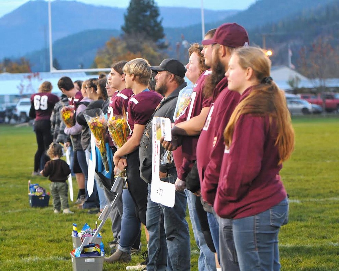 Troy football seniors Braxton Yeadon, Marley Erickson, Rowyn Shupe, Gunnar Weaver, Nathan Sentell and Derek Cole and their family members were honored during Senior Night festivities on Friday, Oct. 20. (Hannah Chumley/The Western News)