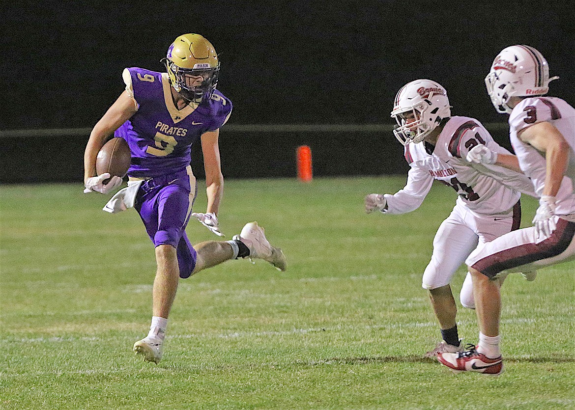 Pirate Cason Graham evades Hamilton player after an interception in last Friday's final game of the season. (Bob Gunderson photo)