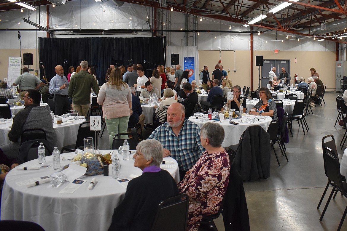 Attendees socialize before the Crossroads Resource Center banquet Saturday.