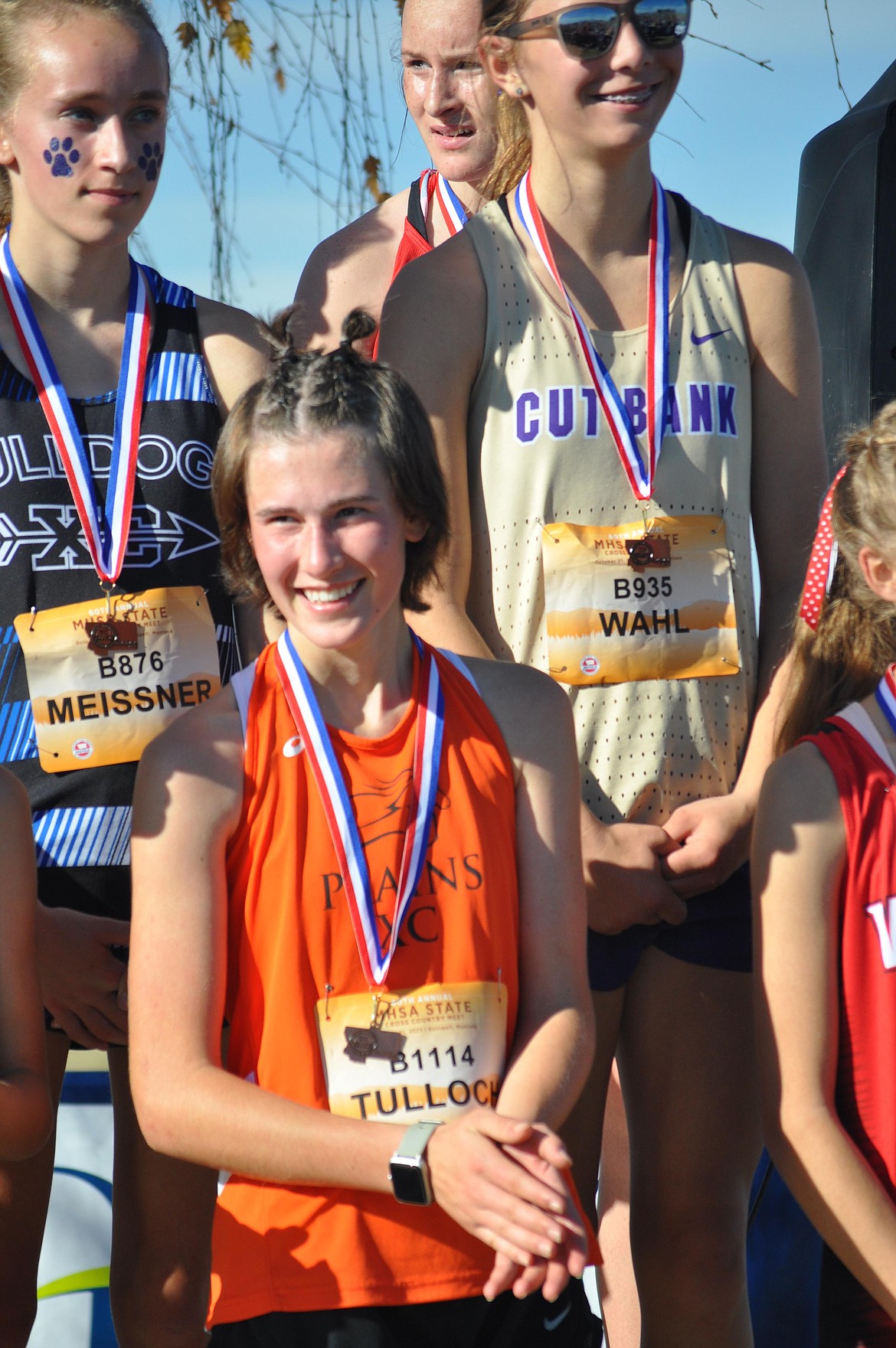 Plains High freshman Marina Tulloch smiles after receiving her fourth-place medal at this past Saturday's MHSA STate Cross Country championships at Rebecca Farms in Kalispell.  (Photo by Sarah Naegeli)