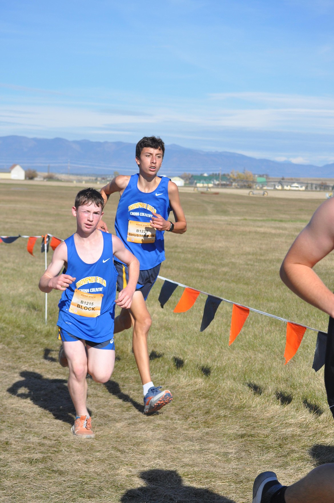 Thompson Falls eighth grader Weston Block (left) runs shoulder to shoulder with teammate Blake Shusterman during Saturday's state cross country championship event in Kalispell.  (Photo by Sarah Naegeli)
