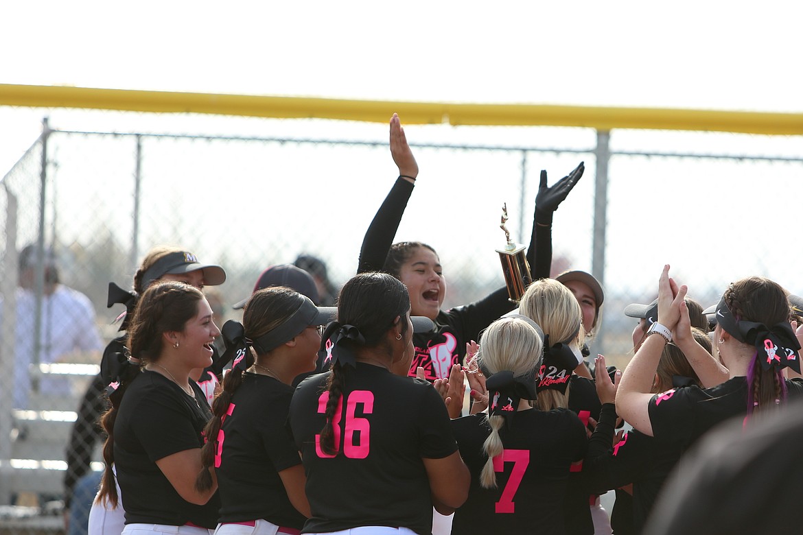 Moses Lake players celebrate with the Columbia Basin Big 9 district tournament trophy after defeating Eastmont 11-5.