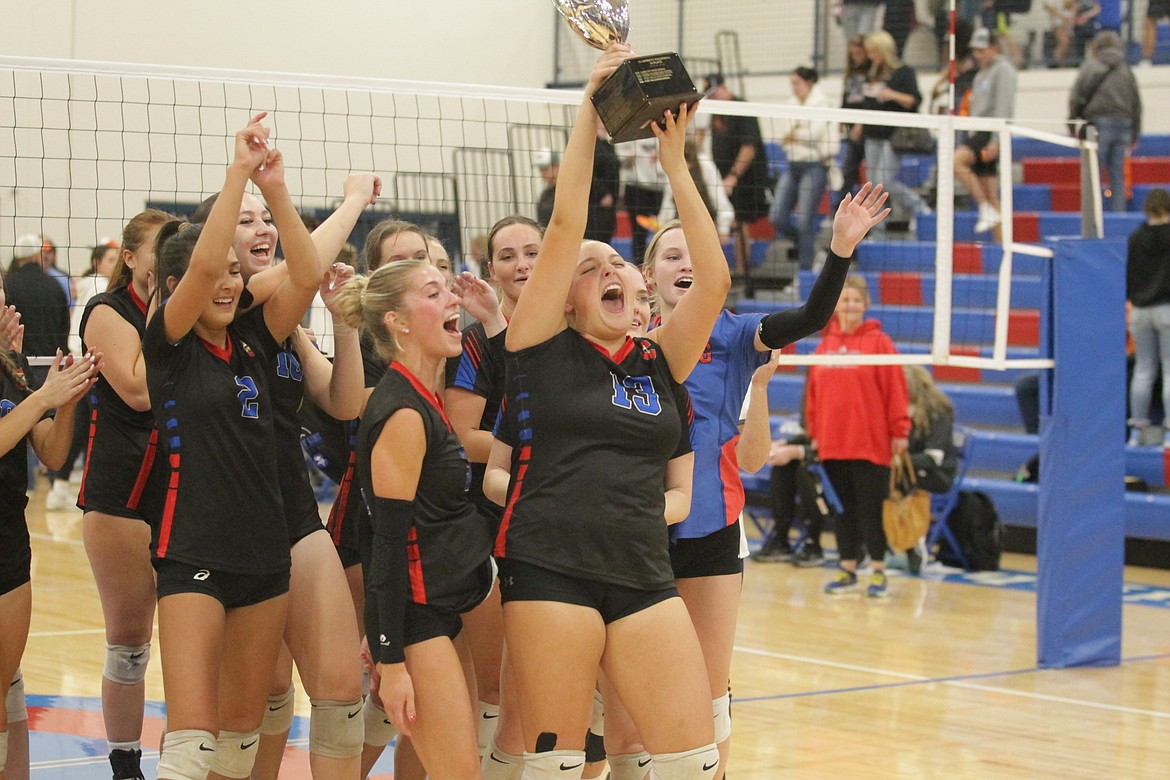 MARK NELKE/Press
Coeur d'Alene senior Olivia Naccarato (13) hoists the trophy after the Vikings won the 5A Region 1 volleyball championship last week.