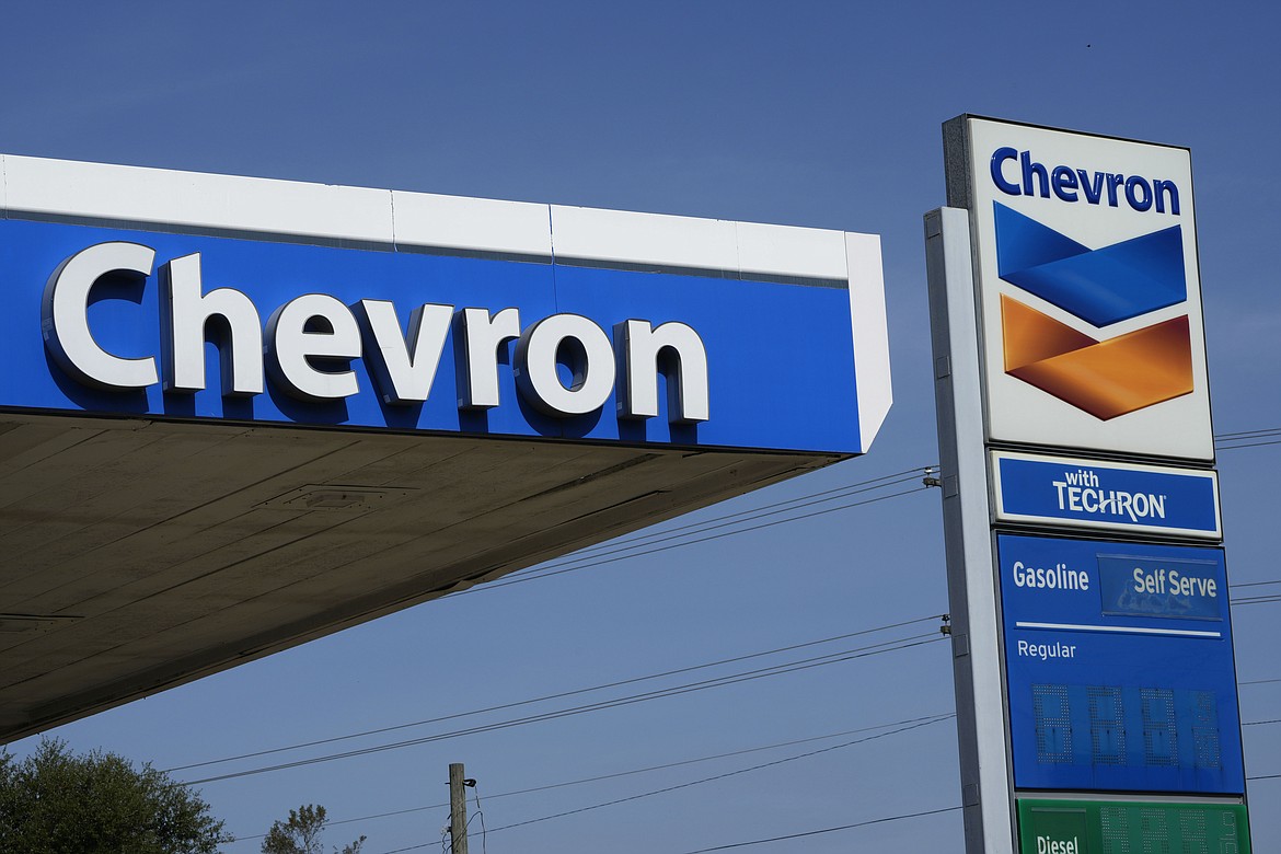 Chevron logos ride atop a gas station in Columbus, Miss., Monday, Oct. 23, 2023. Chevron is buying Hess Corp. for $53 billion as major producers seize the initiative while oil prices surge. (AP Photo/Rogelio V. Solis)