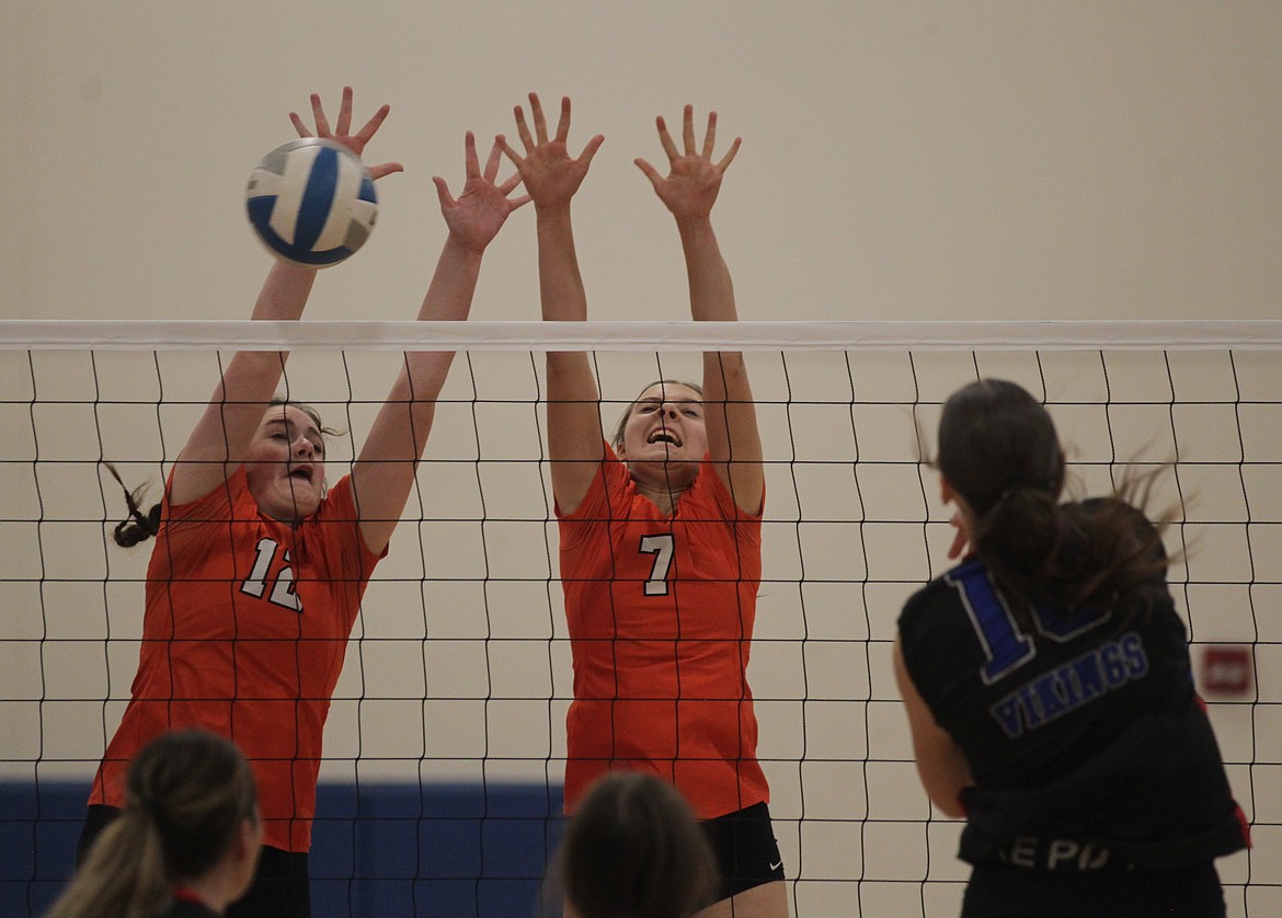 MARK NELKE/Press
Sam Anderson (12) and Trinity Byrne (7) of Post Falls block against Coeur d'Alene in last week's 5A Region 1 volleyball championship match.