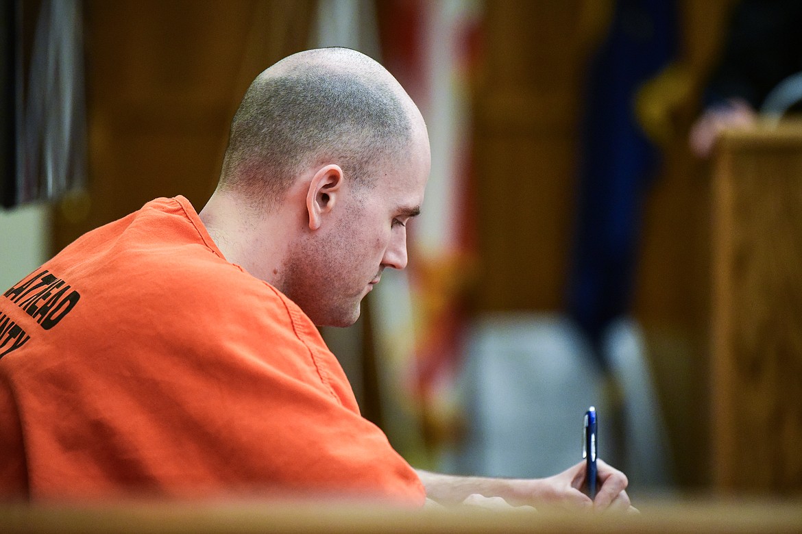 Jonathan Douglas Shaw writes during a motion hearing for a new trial in Flathead County District Court on Wednesday, Oct. 25. (Casey Kreider/Daily Inter Lake)