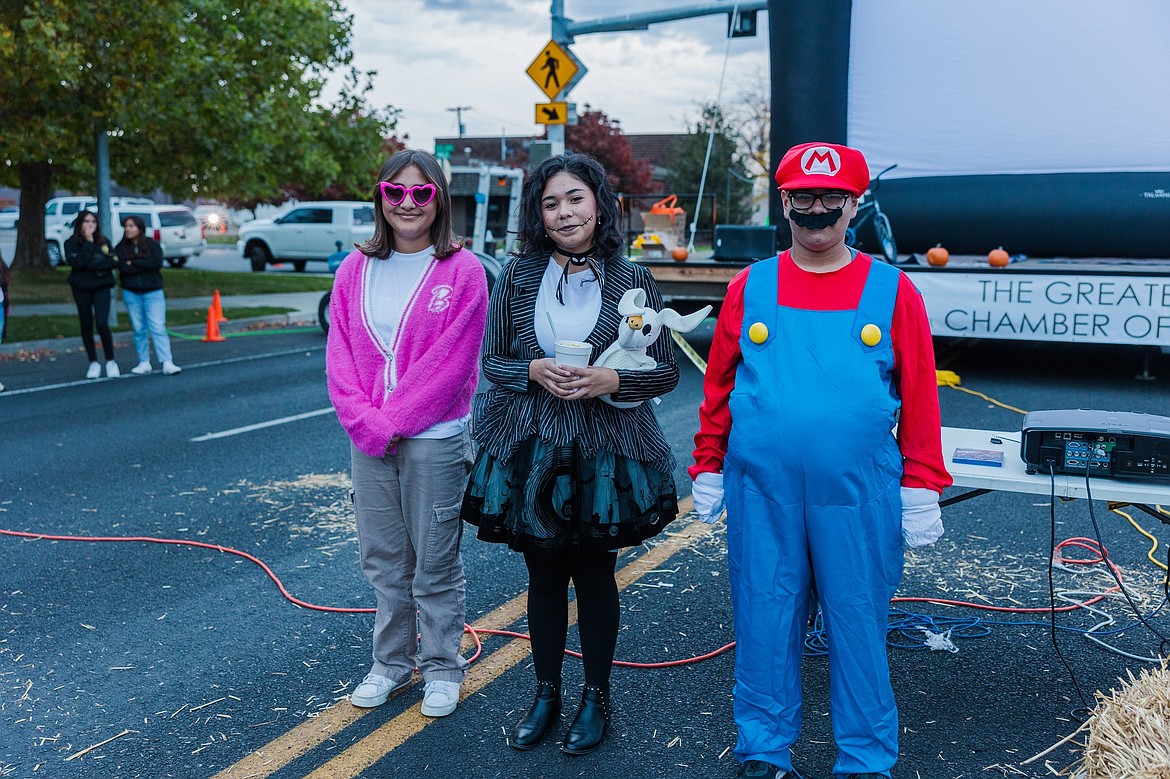 Three youth costume contest winners stand on Main Street in Othello, which was blocked off for Saturday’s Family Fall Festival in front of Othello City Hall.