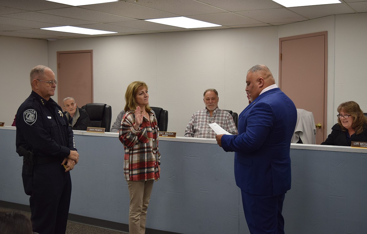 City Administrator Kriss Shuler administers the oath of office to Officer Greg Talbot as he is sworn in to the rank of sergeant.