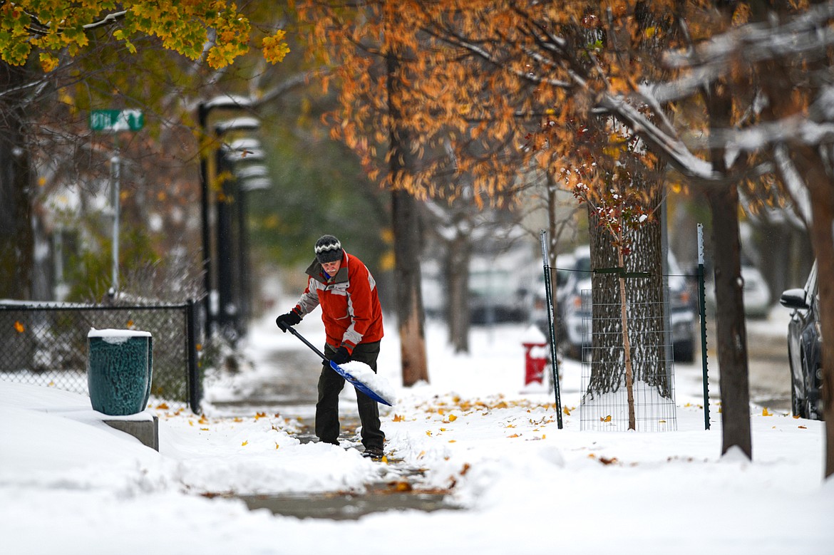 A resident of Fourth Avenue East shovels snow on Wednesday, Oct. 25. (Casey Kreider/Daily Inter Lake)