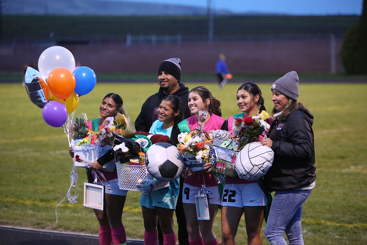 Wahluke seniors smile for photos during the senior ceremony before Tuesday’s game against Kiona-Benton.