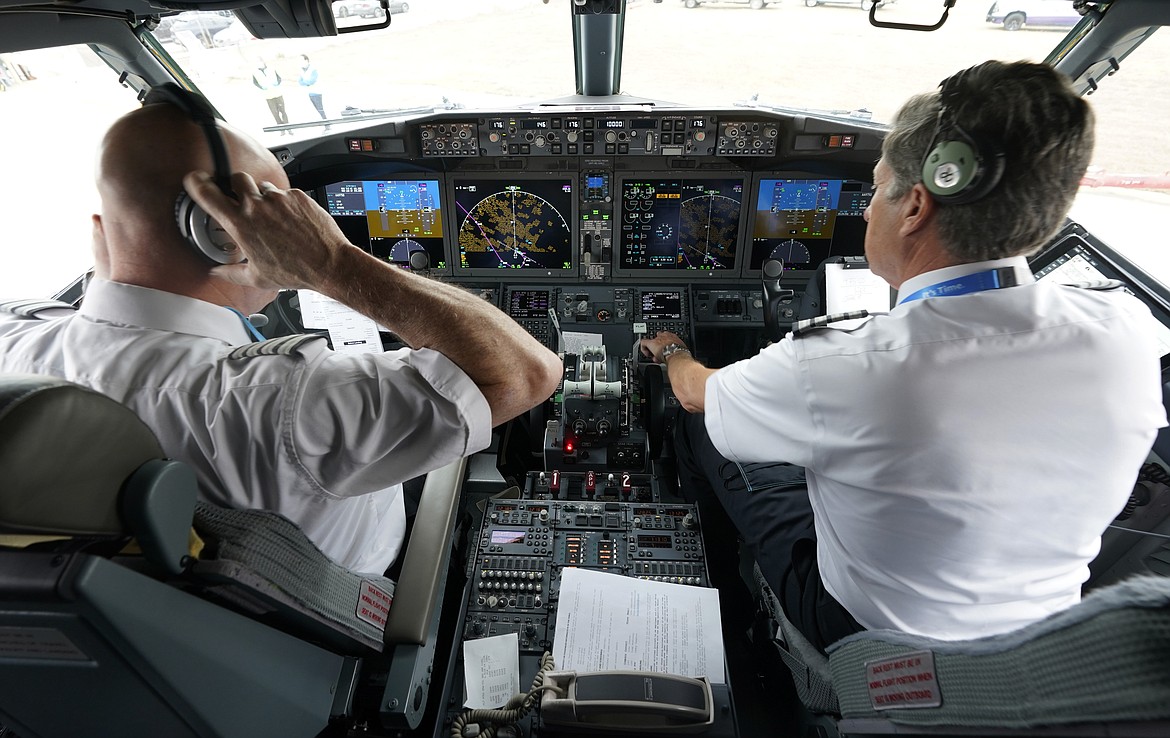 Pilots conduct a pre-flight check in the cockpit of a jet before taking off from Dallas Fort Worth airport in Grapevine, Texas, on Dec. 2, 2020. Aviation experts say the incident on Sunday in which an off-duty pilot, riding in a jump seat in a cockpit, tried to disable a jetliner in midflight renews questions about the threat posed by airline workers who have special access to places where passengers can't go. (AP Photo/LM Otero, File)