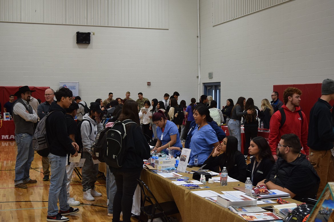 Othello Career Showcase participants representing Columbia Basin Technical Skills Center converse with students Tuesday at Othello High School.