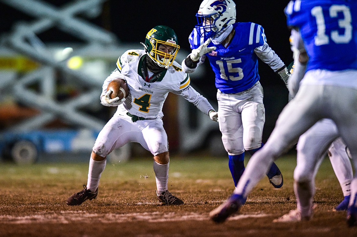Whitefish wide receiver Dane Hunt (4) looks for running room after a reception in the third quarter against Columbia Falls at Satterthwaite Field on Friday, Oct. 27. (Casey Kreider/Daily Inter Lake)