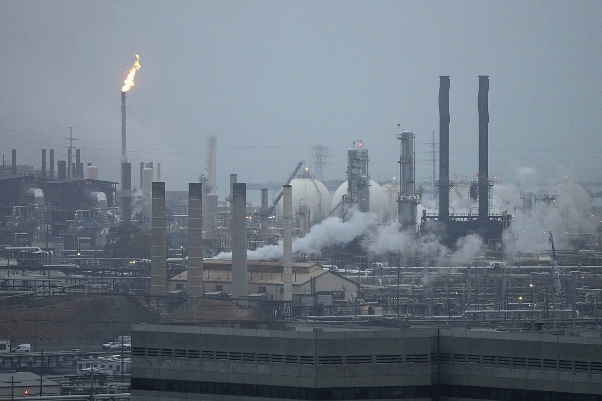 File - Seen is the Chevron Richmond Refinery in this view from Point Richmond, Calif., Tuesday, Oct. 24, 2023. The San Ramon, California, company posted a third-quarter profit of $6.53 billion, or $3.48 per share. Earnings, adjusted for pretax gains, came to $3.05 per share. (AP Photo/Eric Risberg, File)