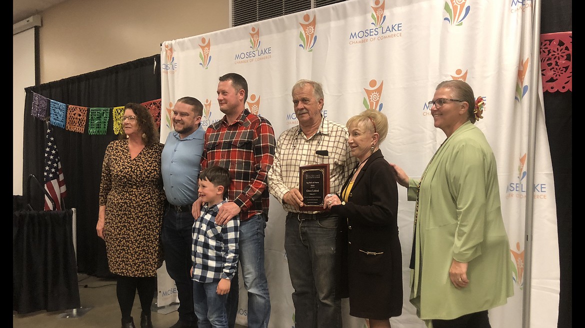 Moses Lake Chamber of Commerce Executive Director Debbie Doran-Martinez, right, presents Glenn Leland and family with the Ag Hall of Fame award on Oct. 17.