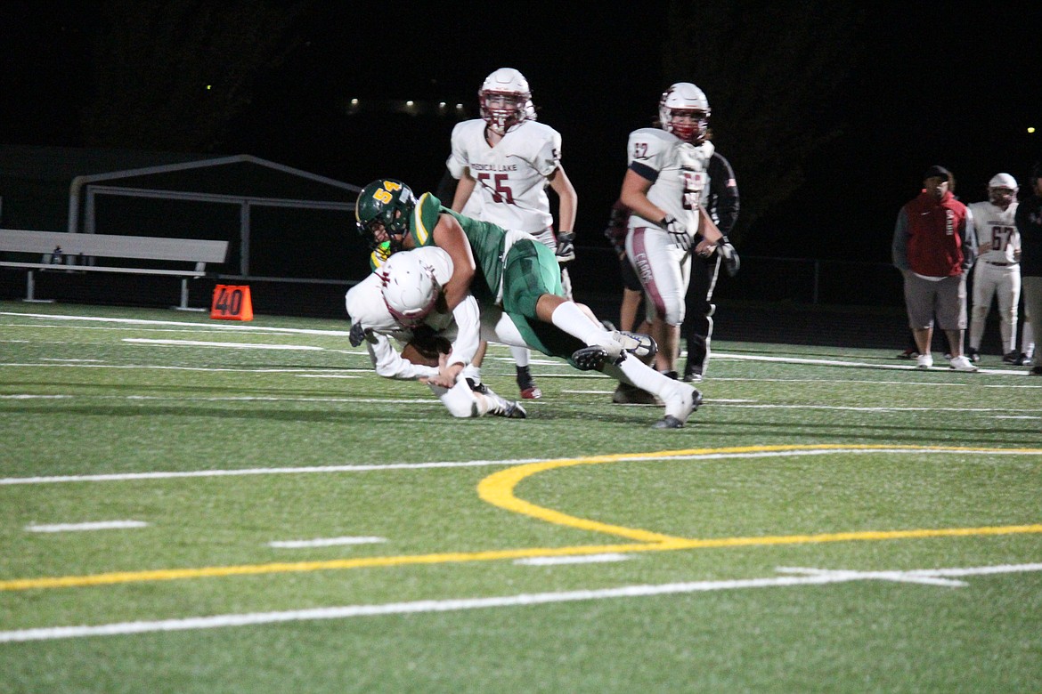 Quincy defensive lineman Jayden Lopez-Garcia (54) takes down a Medical Lake runner in the Jacks’ Homecoming victory Oct. 20.