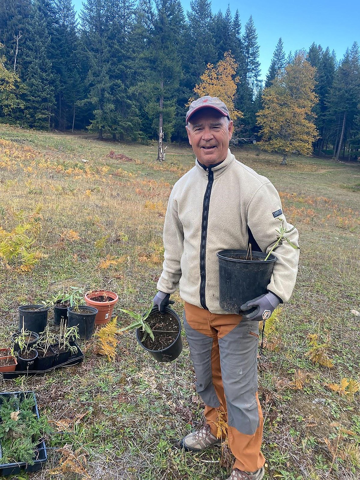 A member of The Mighty Monarchs gets ready to plant milkweed at the Pine Street Woods as part of an effort to attract more Monarch butterflies to the region.