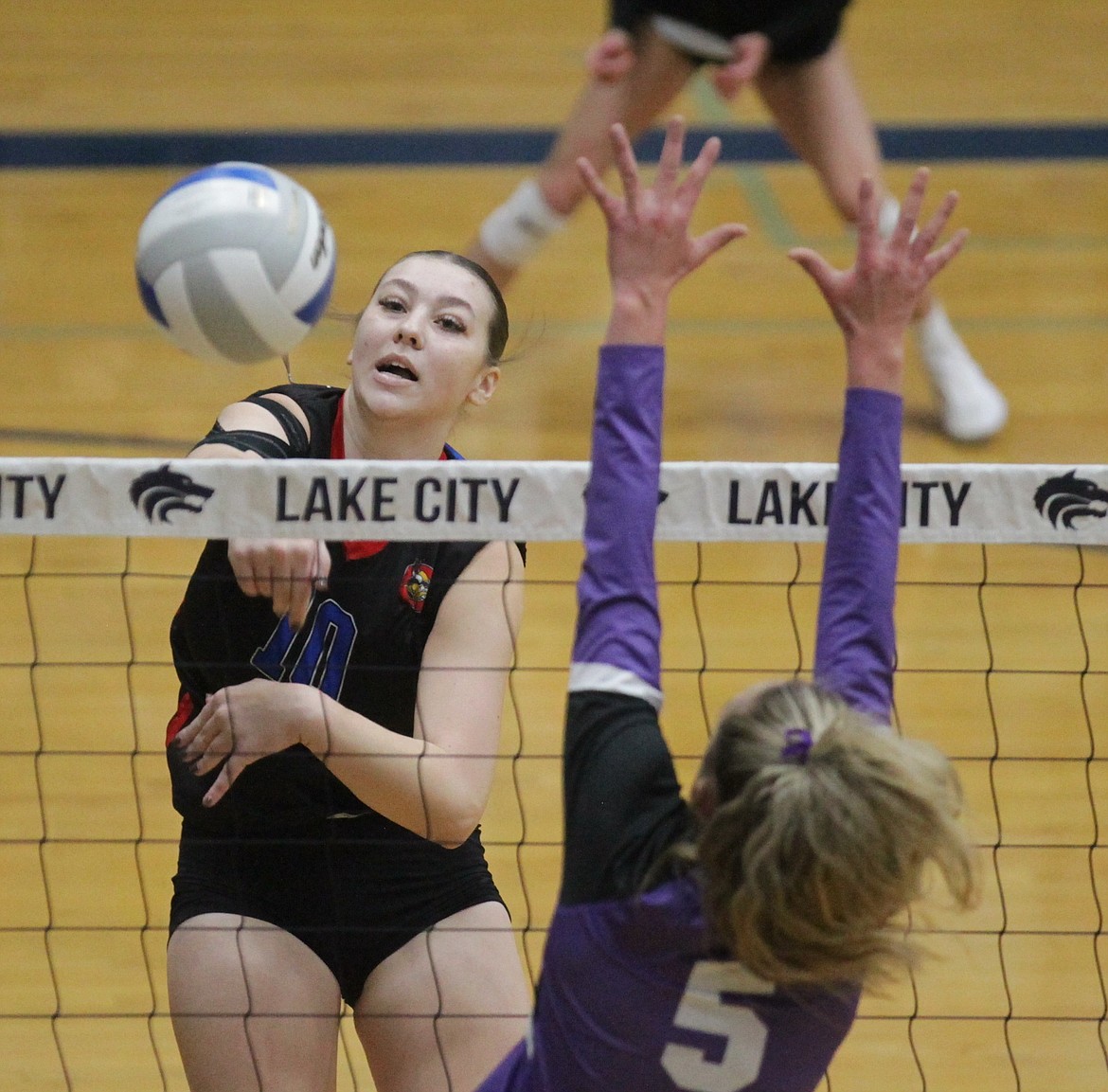 MARK NELKE/Press
Kaydence Green of Coeur d'Alene hits past Chloe Hansen of Rocky Mountain in the first round of the state 5A volleyball tournament Friday at Lake City High.