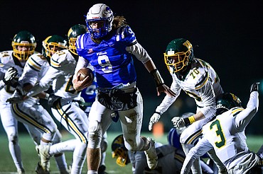 Columbia Falls quarterback Cody Schweikert (9) picks up yardage on a run in the second quarter against Whitefish at Satterthwaite Field on Friday, Oct. 27. (Casey Kreider/Daily Inter Lake)