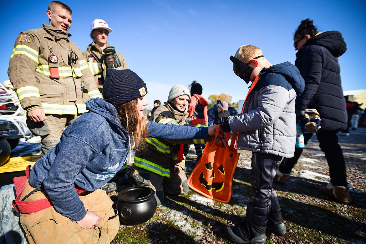 Firefighters with Marion Fire Department hand out candy at the trunk or treat event at the Boys and Girls Club of Glacier Country headquarters in Evergreen on Saturday, Oct. 28. The event was sponsored by the Flathead County Sheriff's Posse, Evergreen Chamber of Commerce and local first responders. (Casey Kreider/Daily Inter Lake)