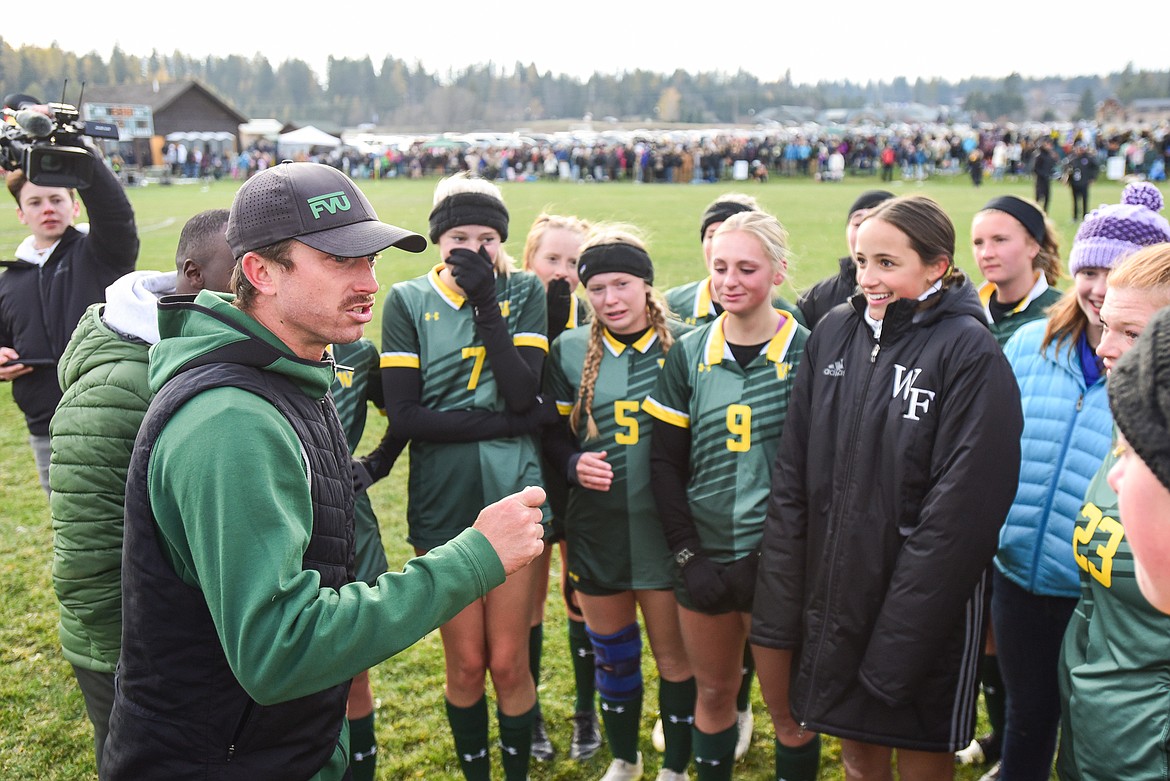 Whitefish head coach Roland Benedict speaks to the Lady Bulldogs after their 3-1 victory over Columbia Falls in the Class A state championship at Smith Fields on Saturday, Oct. 26. (Casey Kreider/Daily Inter Lake)