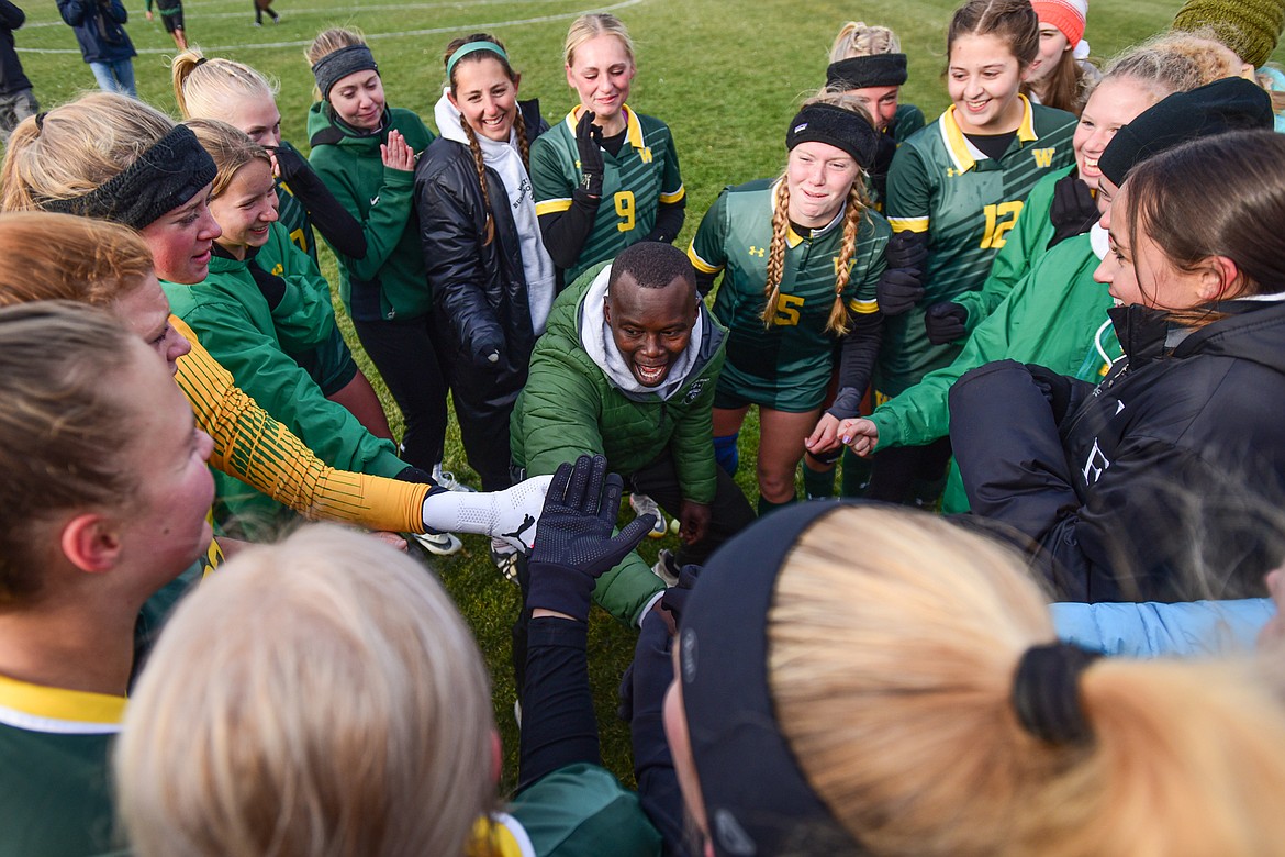 Whitefish assistant coach Victor Kimera celebrates with the team after their 3-1 victory over Columbia Falls in the Class A state championship at Smith Fields on Saturday, Oct. 28. (Casey Kreider/Daily Inter Lake)