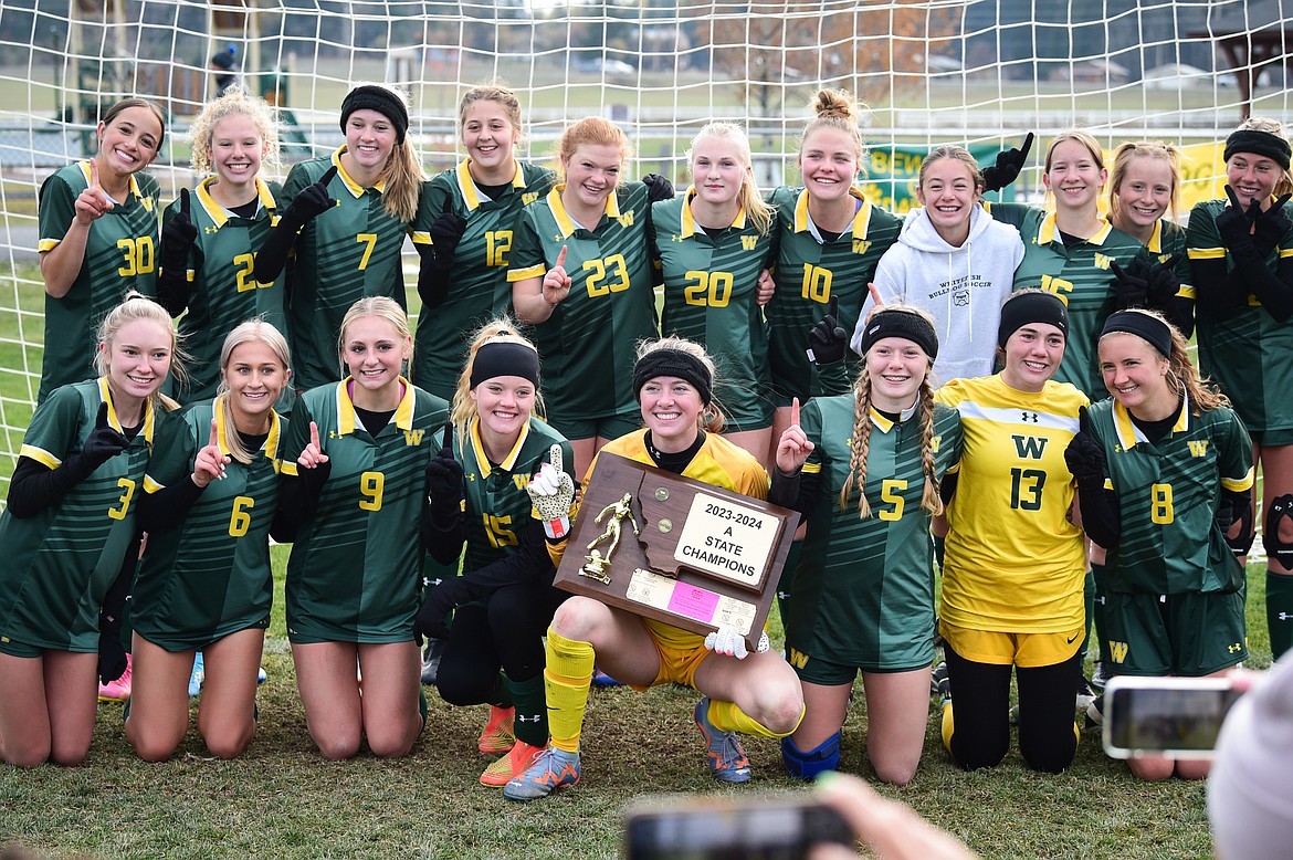 Whitefish holds the Class A state championship trophy after their win over Columbia Falls at Smith Fields on Saturday, Oct. 28. (Casey Kreider/Daily Inter Lake)