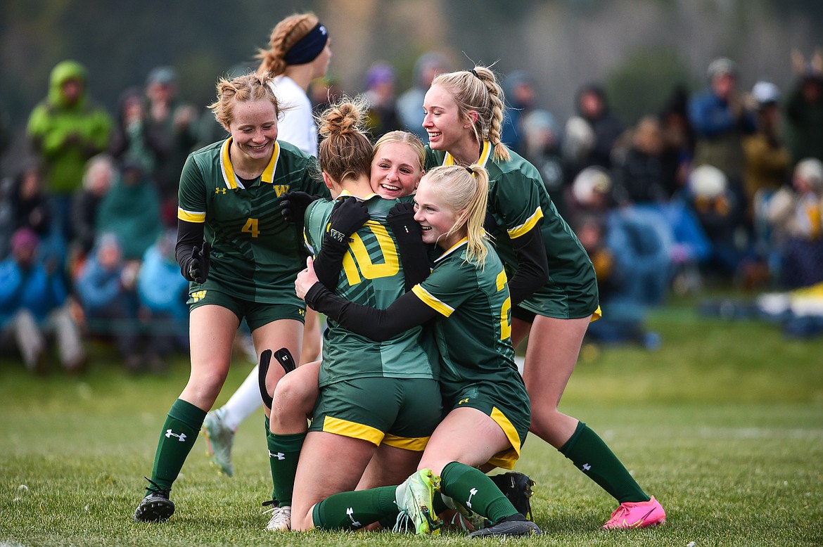 Whitefish's Georgia Morell (4), Olivia Genovese (10), Delaney Smith (9), Isabelle Cooke (20) and Macie Schmidt (7) celebrate after Smith's goal in the second half against Columbia Falls in the Class A state championship at Smith Fields on Saturday, Oct. 26. (Casey Kreider/Daily Inter Lake)