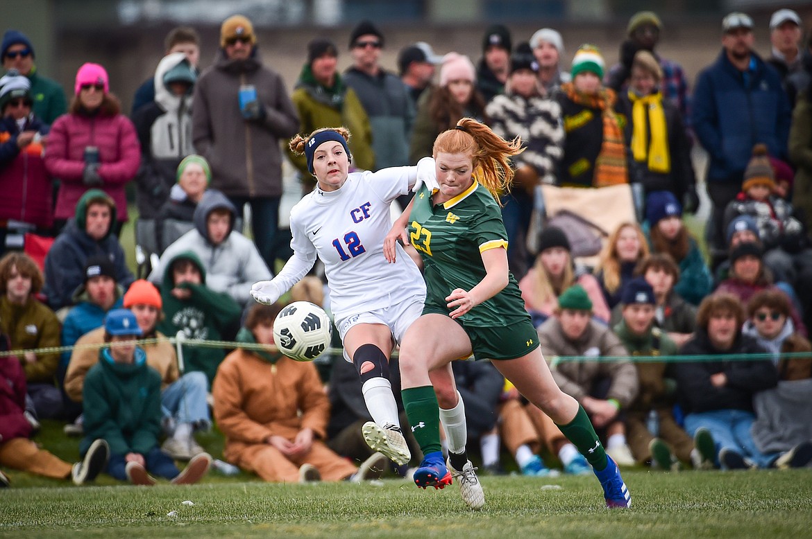 Columbia Falls Josie Harris (12) passes into the box defended by Whitefish's Charlotte Perkins (23) in the first half of the Class A state championship at Smith Fields on Saturday, Oct. 26. (Casey Kreider/Daily Inter Lake)