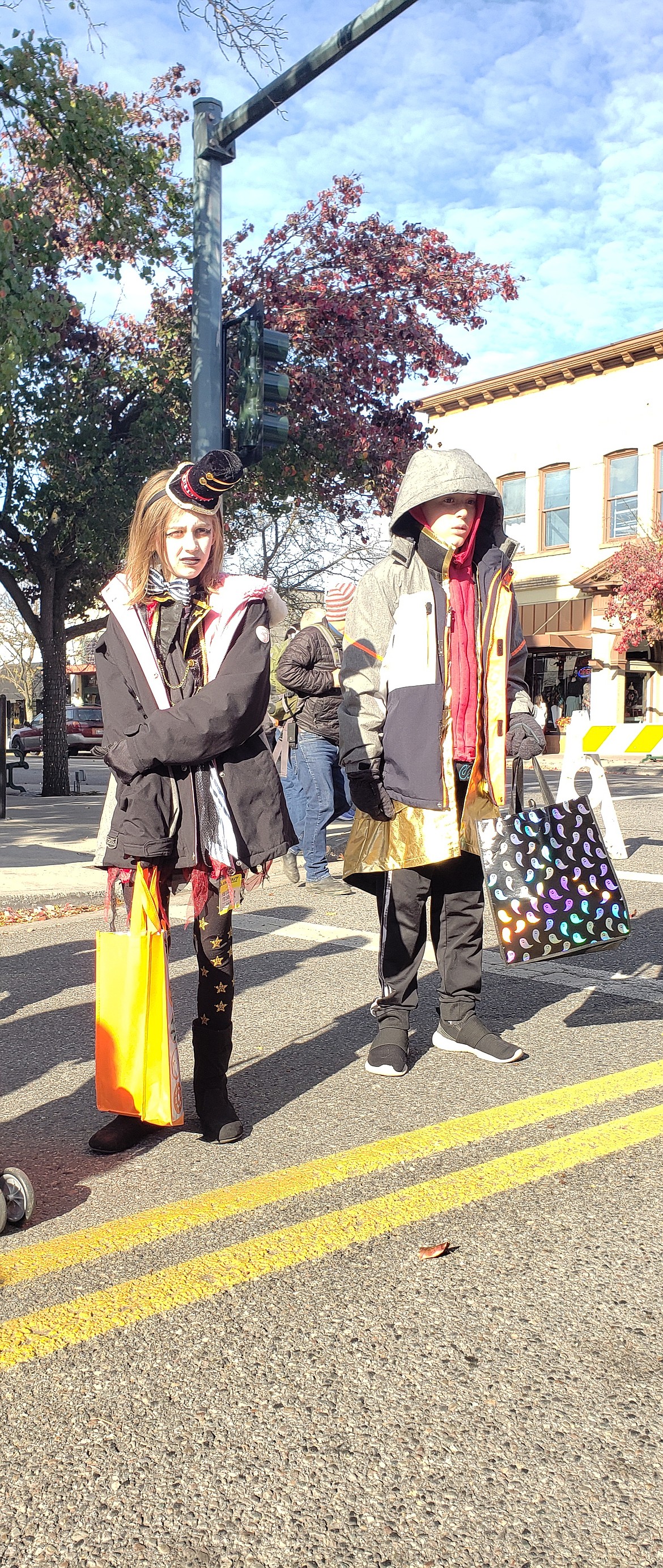 From left, Kyler and Henleigh Otto dressed up in costumes and coats to participate in the Fifth Street Farmer’s Harvest Market and Apple Palooza on Saturday. They were treated with candy, apples and candy apples.