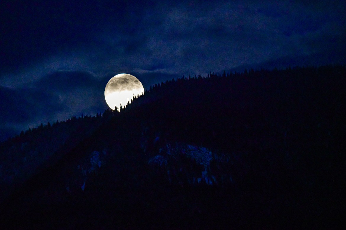 The moon rises behind the flank of Columbia Mountain on Friday, Oct. 27. (Casey Kreider/Daily Inter Lake)