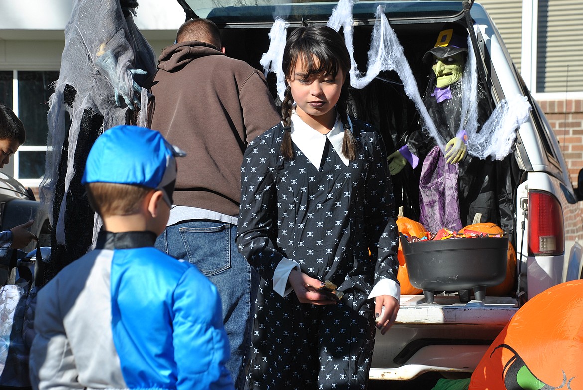 Angel, dressed as Wednesday from the Addams Family passes out candy Saturday afternoon.(Mineral Independent/Amy Quinlivan)