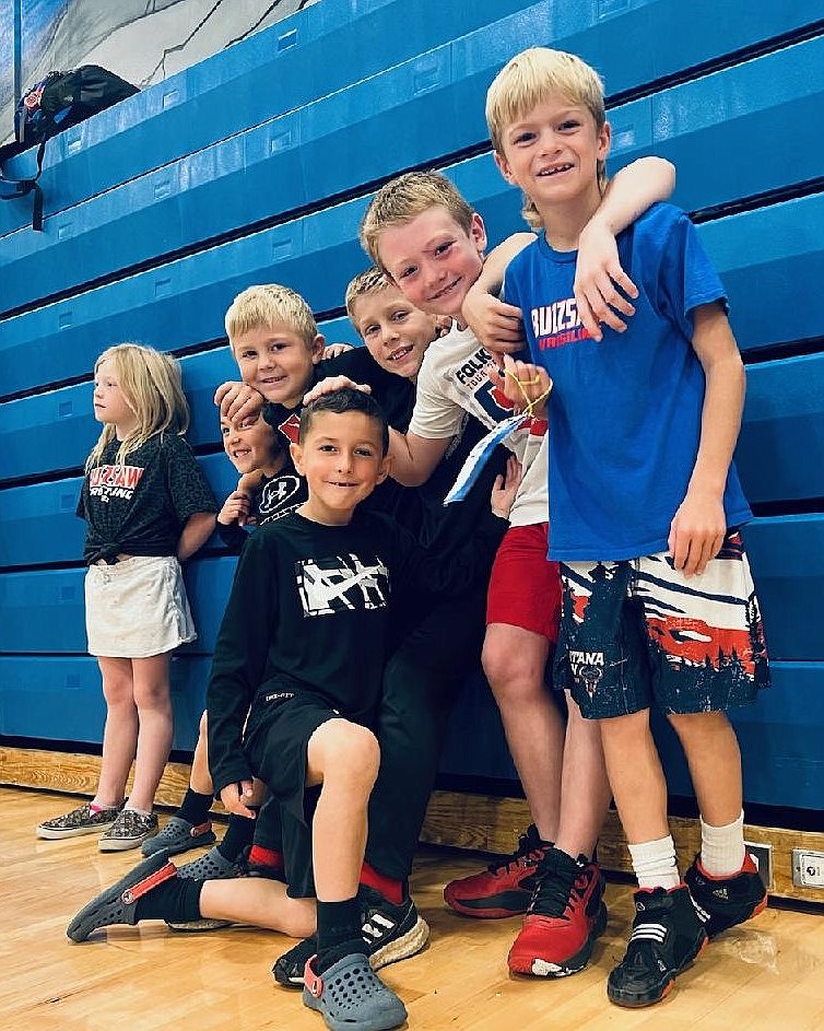 Courtesy photo
Buzzsaw Wrestling Club fans and athletes holding up the bleachers at a North Idaho Wrestling League tournament at Coeur d'Alene High. Standing from left are Lala Underdahl, Nathan Jennings, James Cam Howard, Rylan Howard, Archer Underdahl and Bodie Stanley, and Blake Jennings in front.