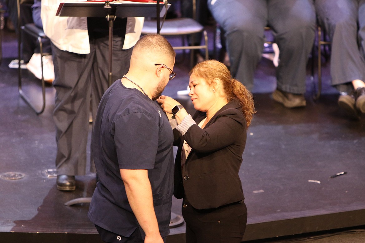 A graduate of the nursing program at Wenatchee Valley College receives his pin in 2022.