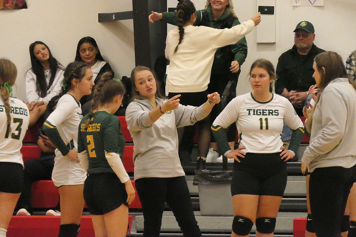 St. Regis volleyball coach Kianna Barnett goes over strategy with her Lady Tigers team during a time out at the District 14C championship in Hot Springs last week. (Chuck Bandel/VP-MI)