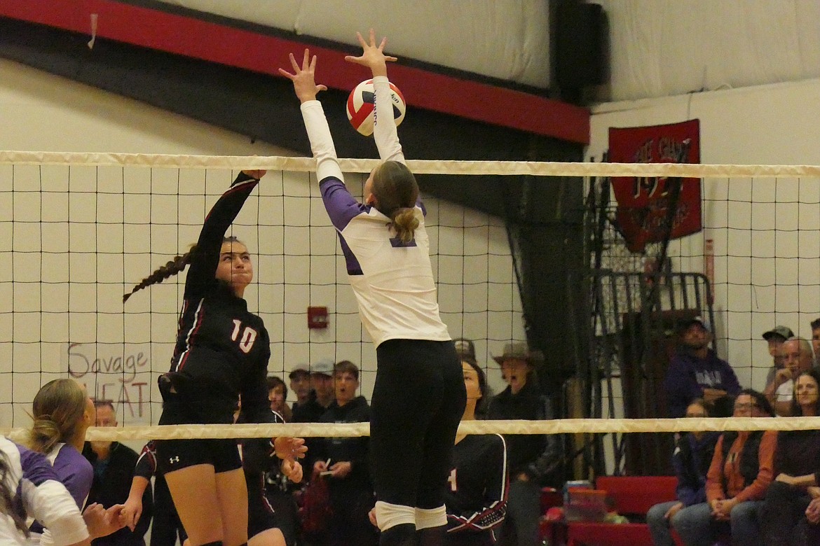 Charlo's Aida Cote, (#2, white jersey) goes up to block a shot by Hot Springs' sophomore Kara Christensen during their District 14C championship game Friday night in Hot Springs.  (Chuck Bandel/VP-MI)